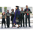 Ieshia Champs in graduation robe with family.