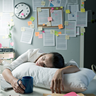 Worker sleeping at desk.