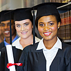 Library with row of people in caps and gowns.