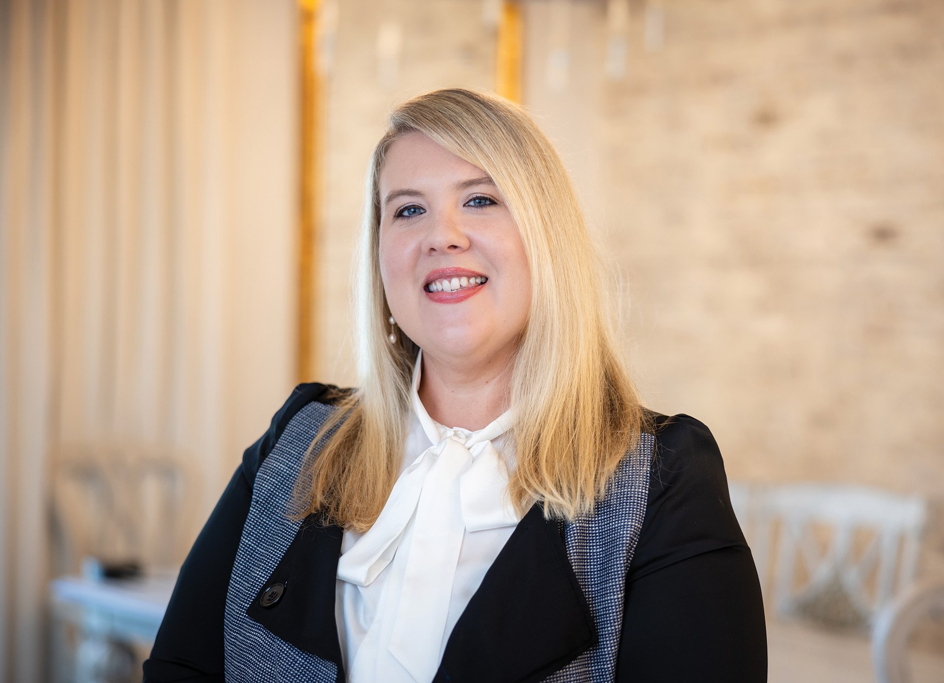 Smiling blonde woman in business attire