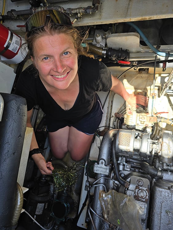 Woman in the bowels of a ship amid the engine parts