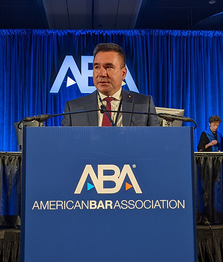Canadian Bar Association president Brad Regehr stands at a podium
