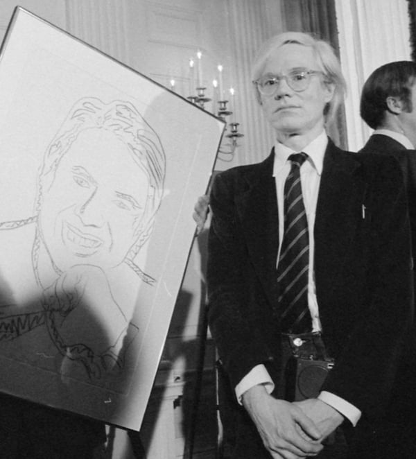 Andy Warhol standing in 1977