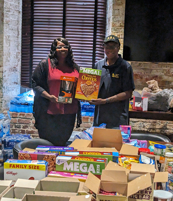 Man and woman in a distribution center with donations