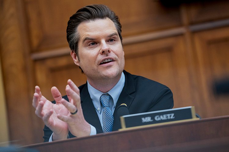 Man in wood paneled congressional hearing room