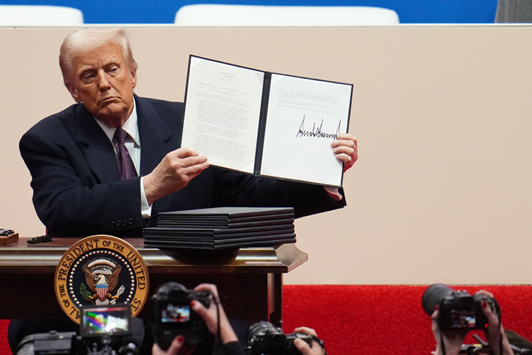 Trump holding a signed order