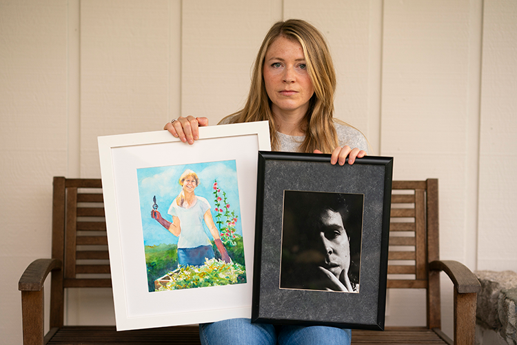 Young woman holding a painting and a photograph