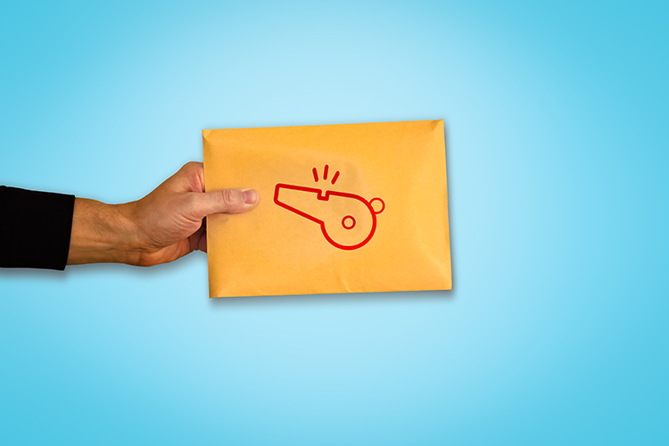 Hand holding an envelope with a red whistle printed on it